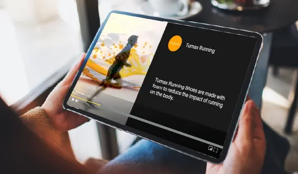 A person watching YouTube on an iPad with content playing on screen, connecting online video with a brand's engagement to the digital ecosystem.