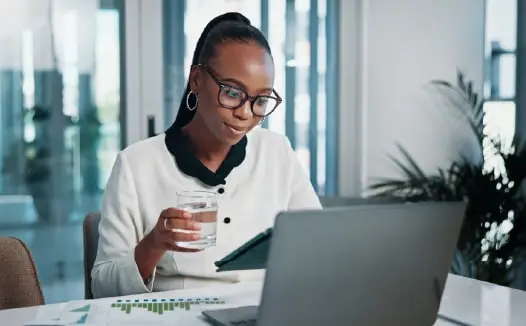 Professional reviewing CRM-based targeting results on a laptop for B2B digital marketing.